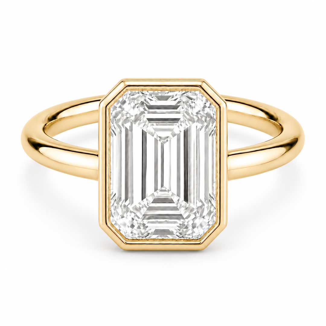 The Paragon emerald-cut lab diamond bezel ring in 14K yellow gold, front view on white