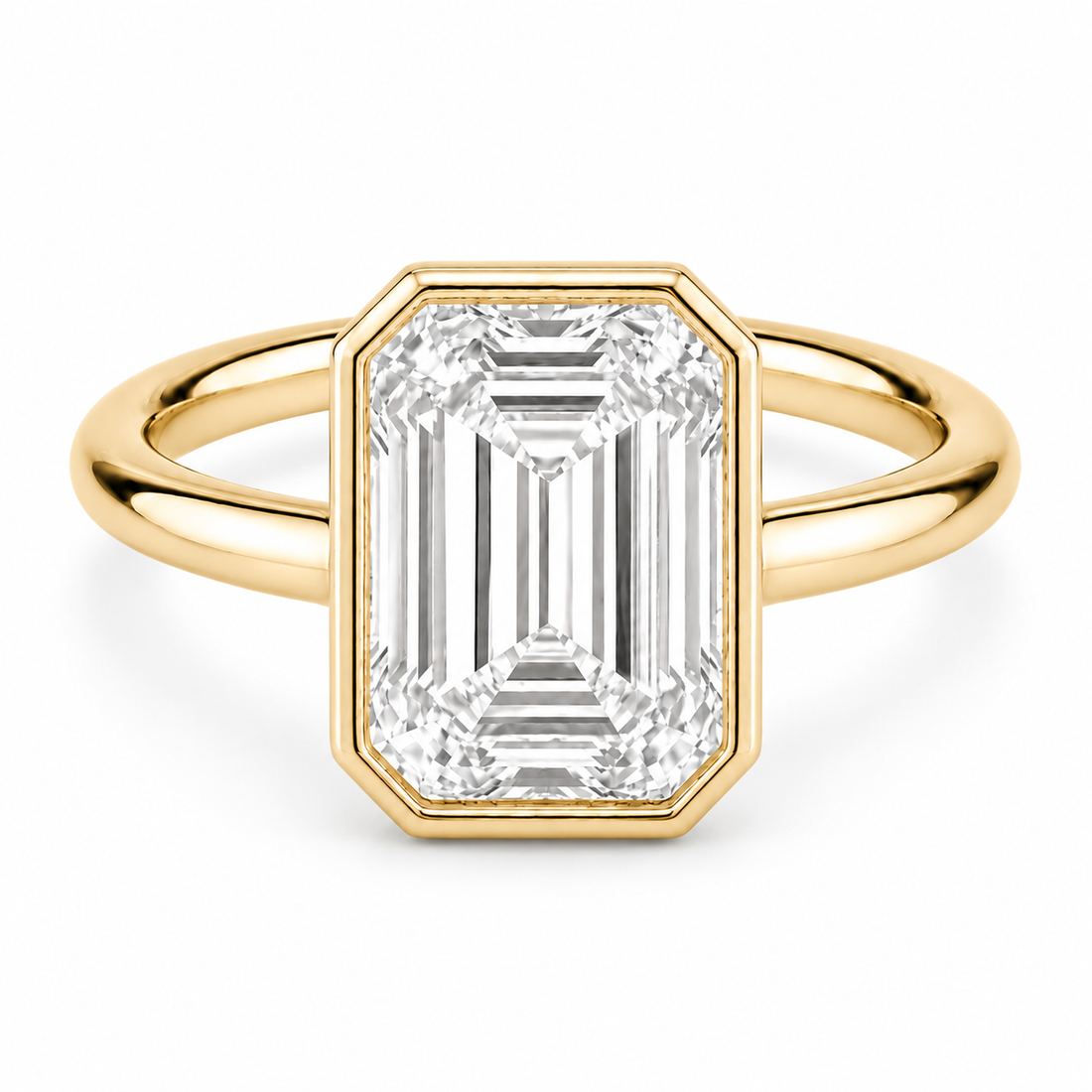 The Paragon emerald-cut lab diamond bezel ring in 14K yellow gold, front view on white
