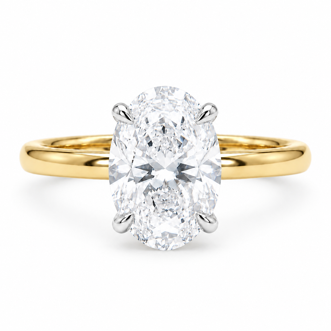 Oval lab diamond engagement ring in two-tone gold, front view on white