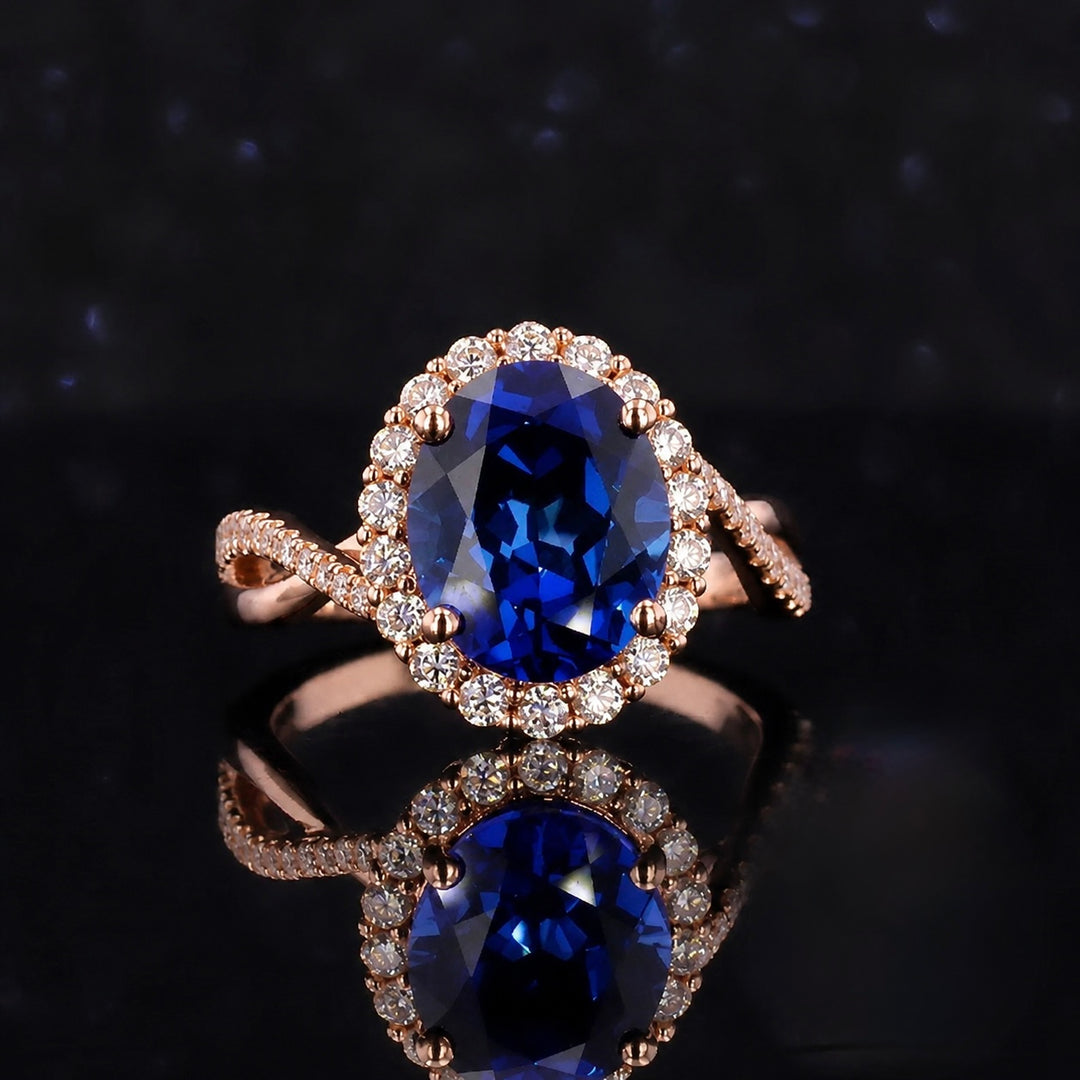 The Twisted Diana — Diamond Halo/Twist Band Oval Blue Sapphire Ring