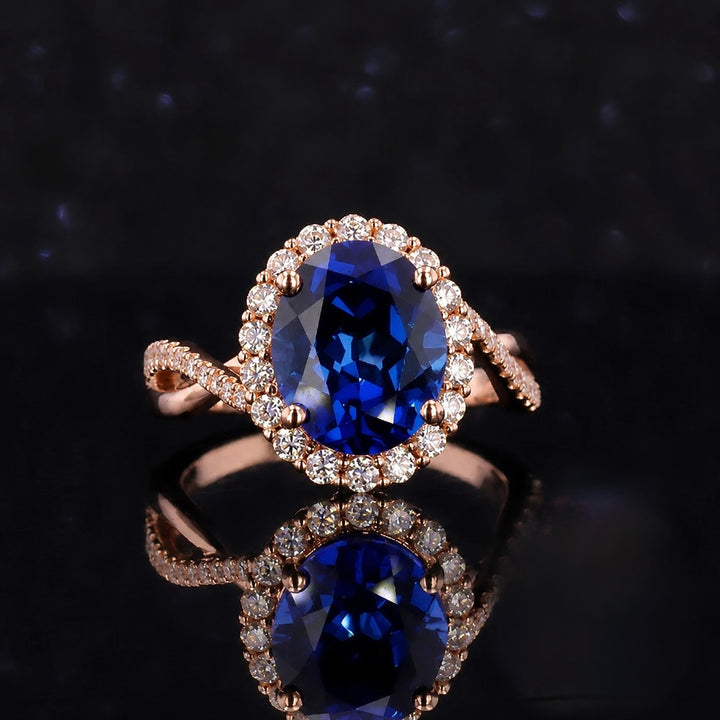 The Twisted Diana — Diamond Halo/Twist Band Oval Blue Sapphire Ring