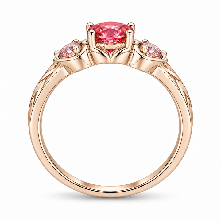 Atoms & Impact pink sapphire three-stone ring in champagne rose gold, profile view on a clean white background