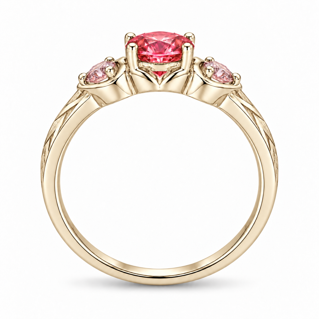 Atoms & Impact pink sapphire three-stone ring in champagne yellow gold, profile view on a clean white background