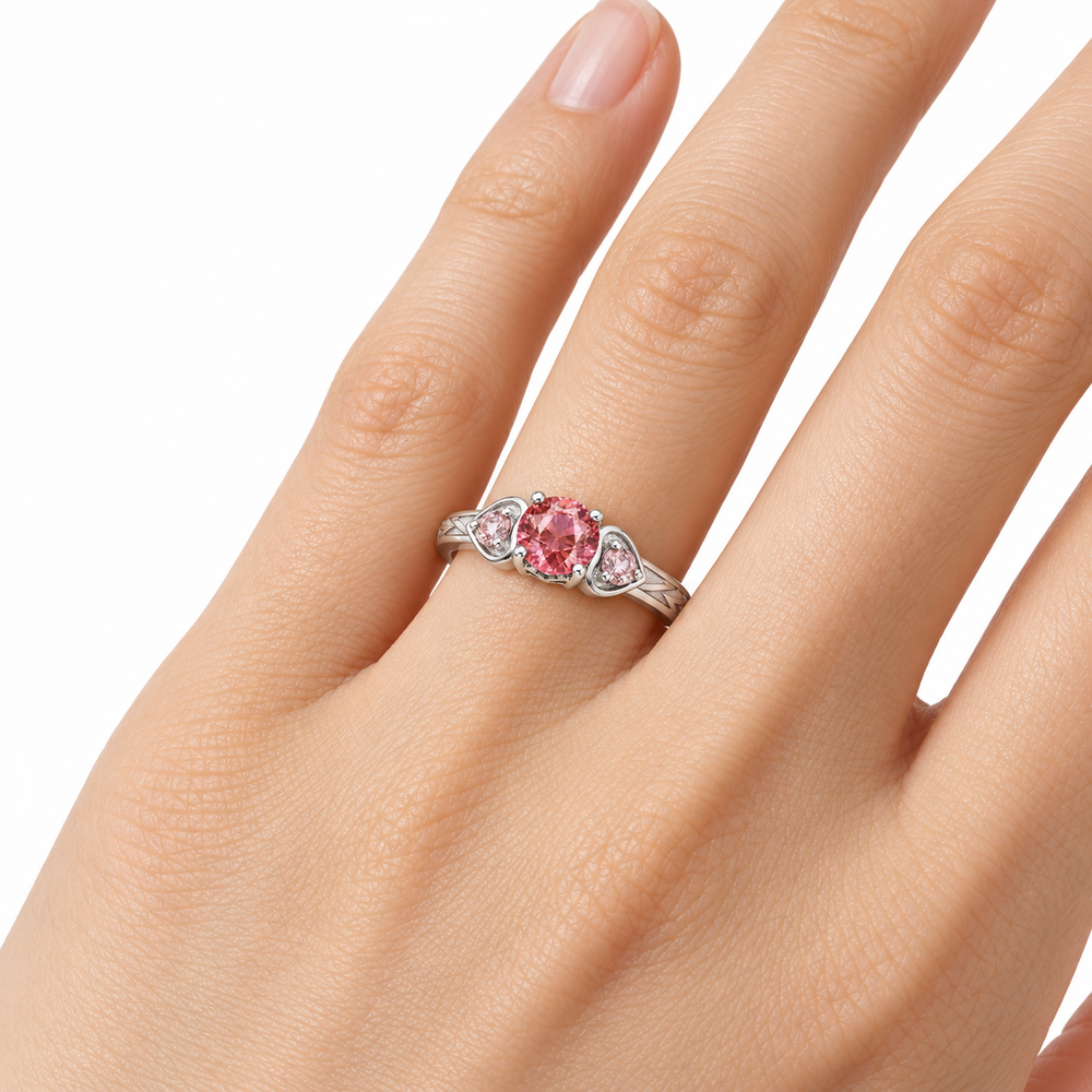 Atoms & Impact pink sapphire three-stone ring in white gold, wearing view on a clean white background