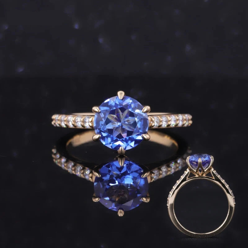 The Bluebell round lab blue sapphire ring with floral prongs and diamond half-eternity band