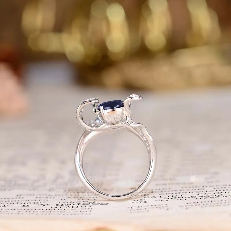 Oval Cut Blue Sapphire with Crushed Halo Ring in Platinum-Plated 925 Sterling Silver