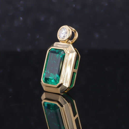 7x10mm Lab Emerald Moissanite Pendant with Moissanite Bezel Setting in 18K Yellow Gold Pendant
