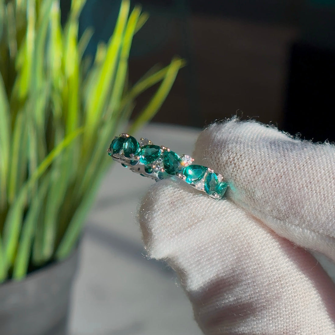 Pear emerald and round diamond eternity band, view 7