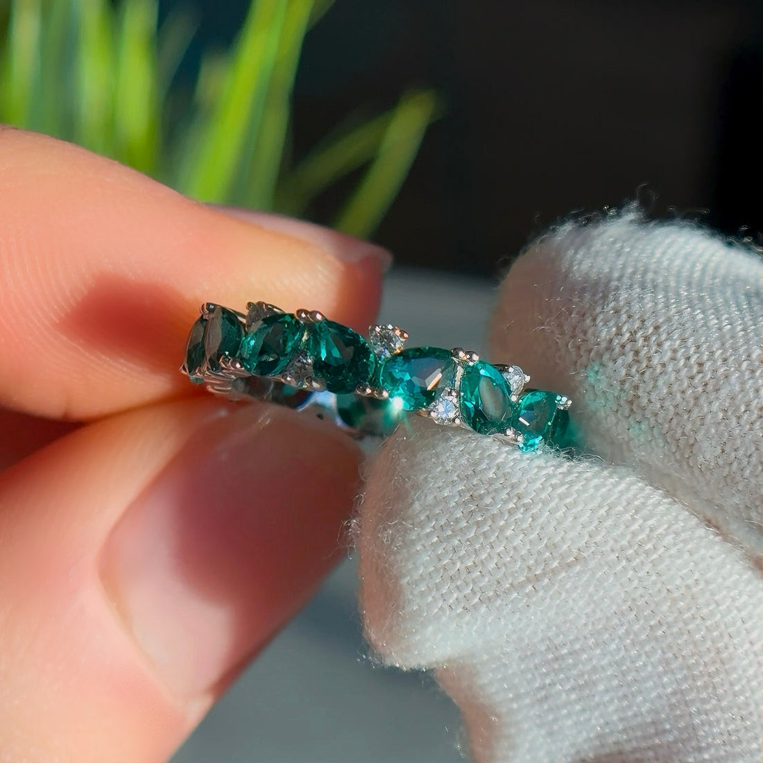 Pear emerald and round diamond eternity band, view 8