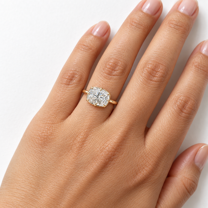 The Camellia east-west cushion lab diamond ring in 14K yellow gold, on the hand