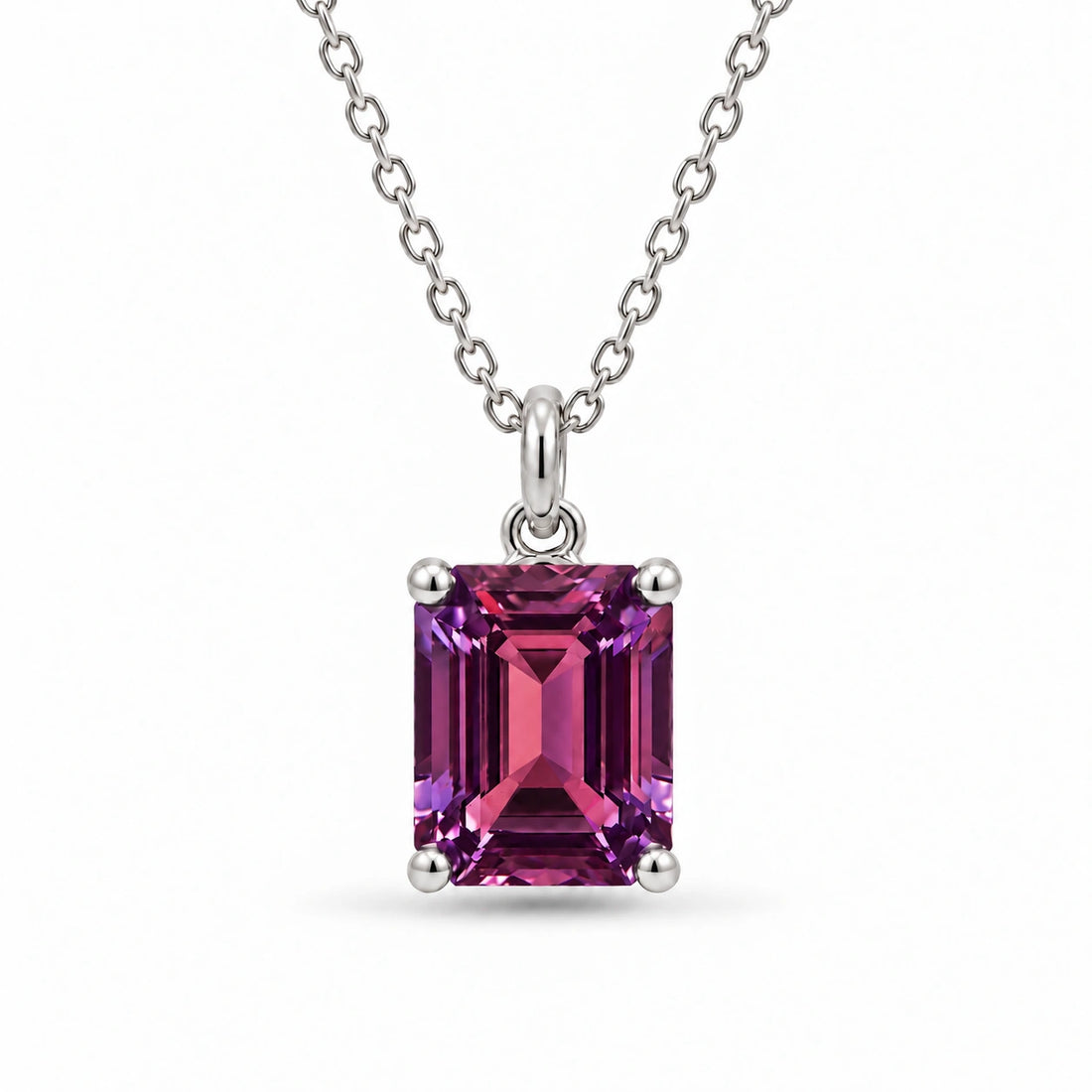 Emerald-Cut Lab Alexandrite Pendant in Platinum 950 under warm indoor light, alexandrite color change