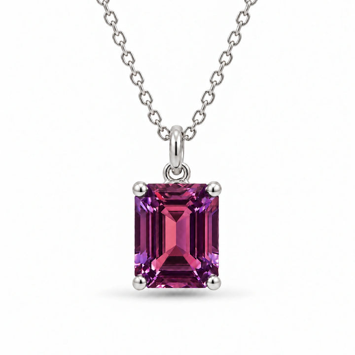Emerald-Cut Lab Alexandrite Pendant in Platinum 950 under warm indoor light, alexandrite color change