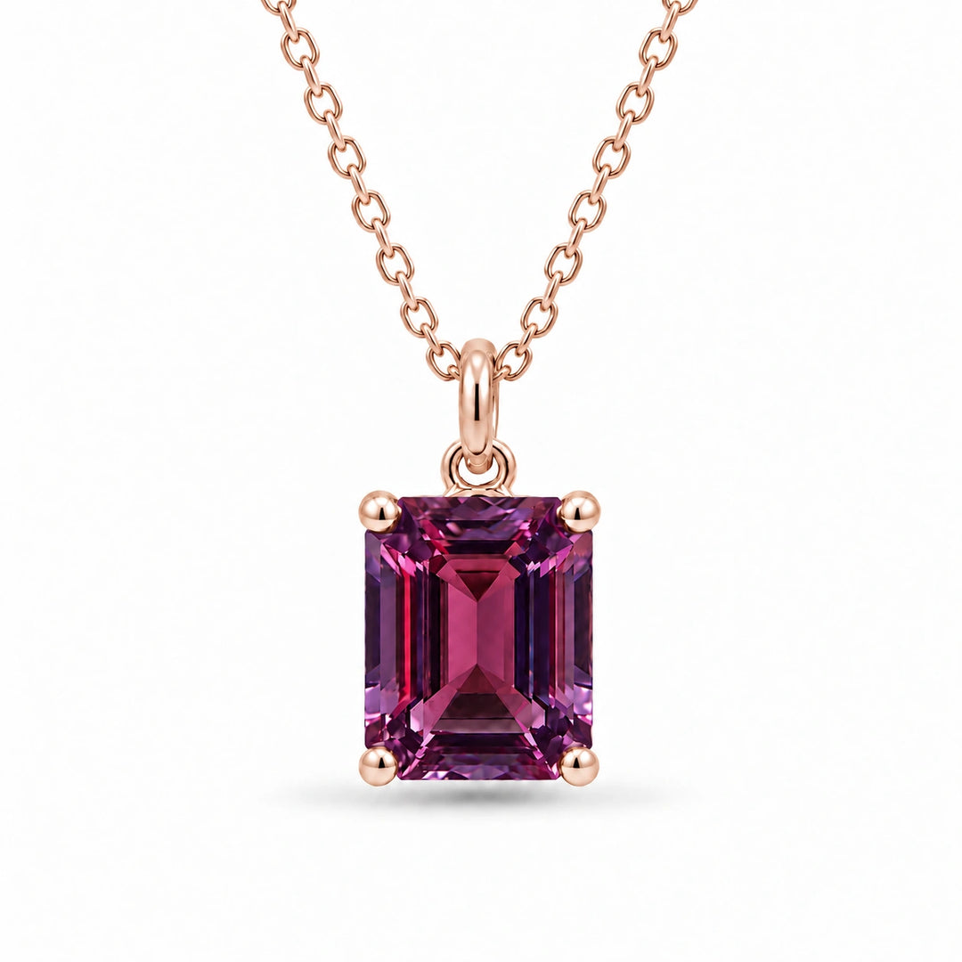 Emerald-Cut Lab Alexandrite Pendant in 14K Rose Gold under warm indoor light, alexandrite color change