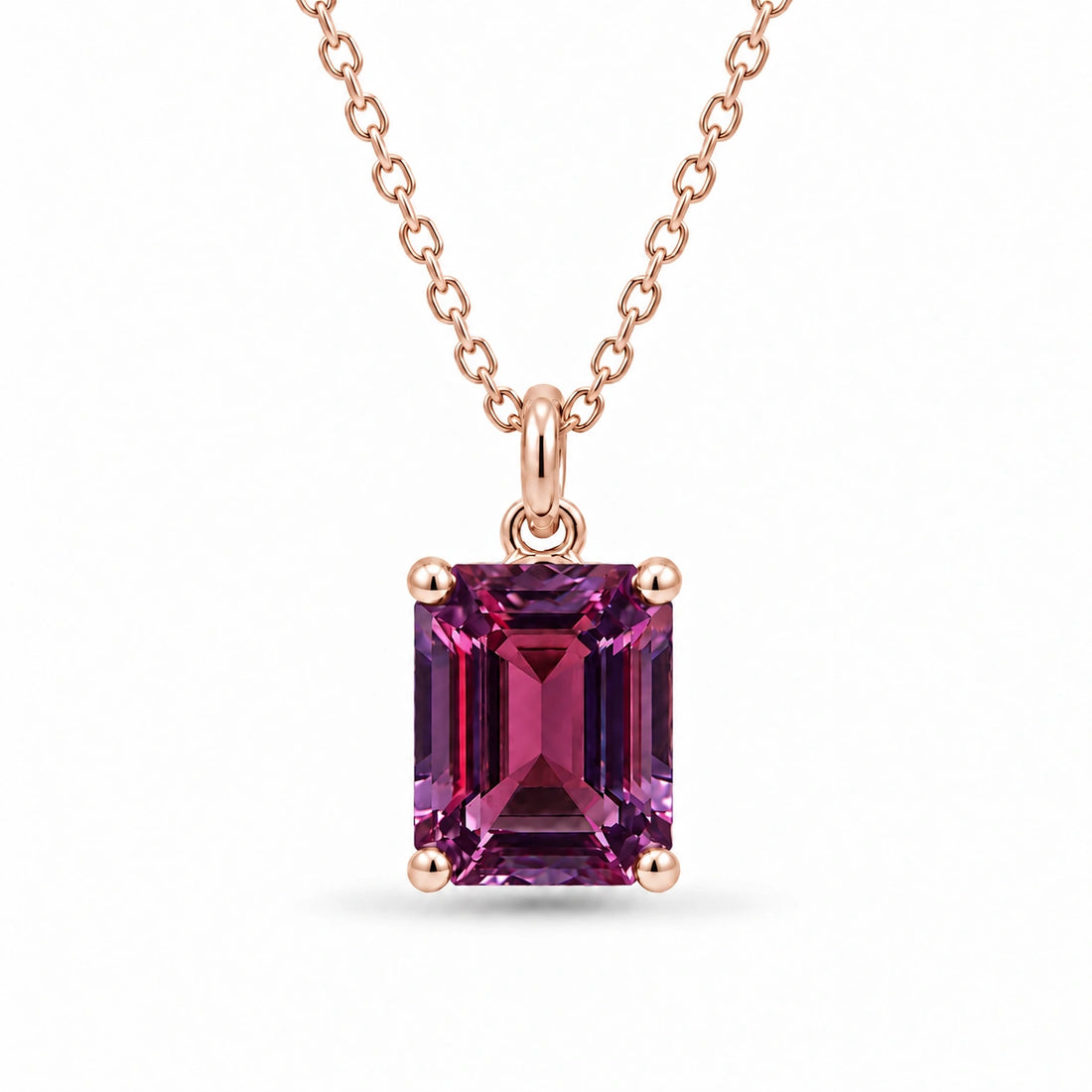 Emerald-Cut Lab Alexandrite Pendant in 14K Rose Gold under warm indoor light, alexandrite color change
