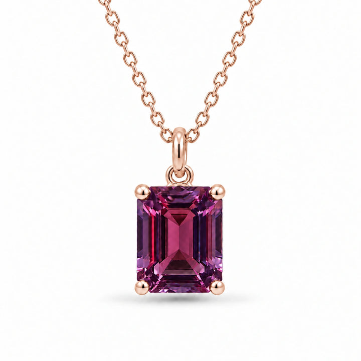 Emerald-Cut Lab Alexandrite Pendant in 14K Rose Gold under warm indoor light, alexandrite color change