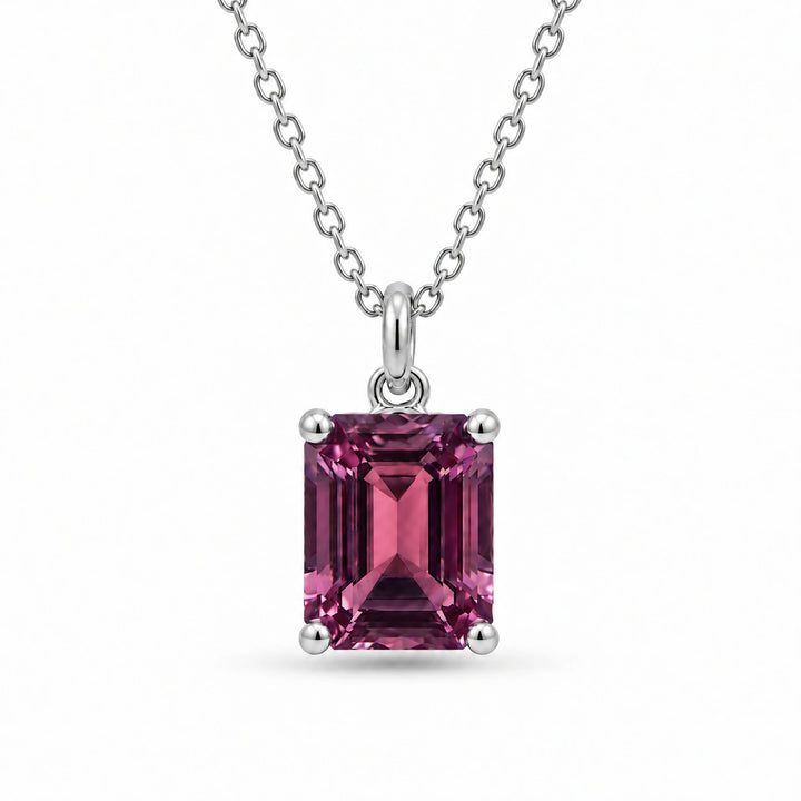 Emerald-Cut Lab Alexandrite Pendant in 14K White Gold under warm indoor light, alexandrite color change