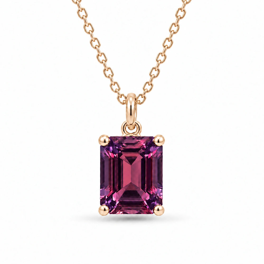 Emerald-Cut Lab Alexandrite Pendant in 14K Yellow Gold under warm indoor light, alexandrite color change