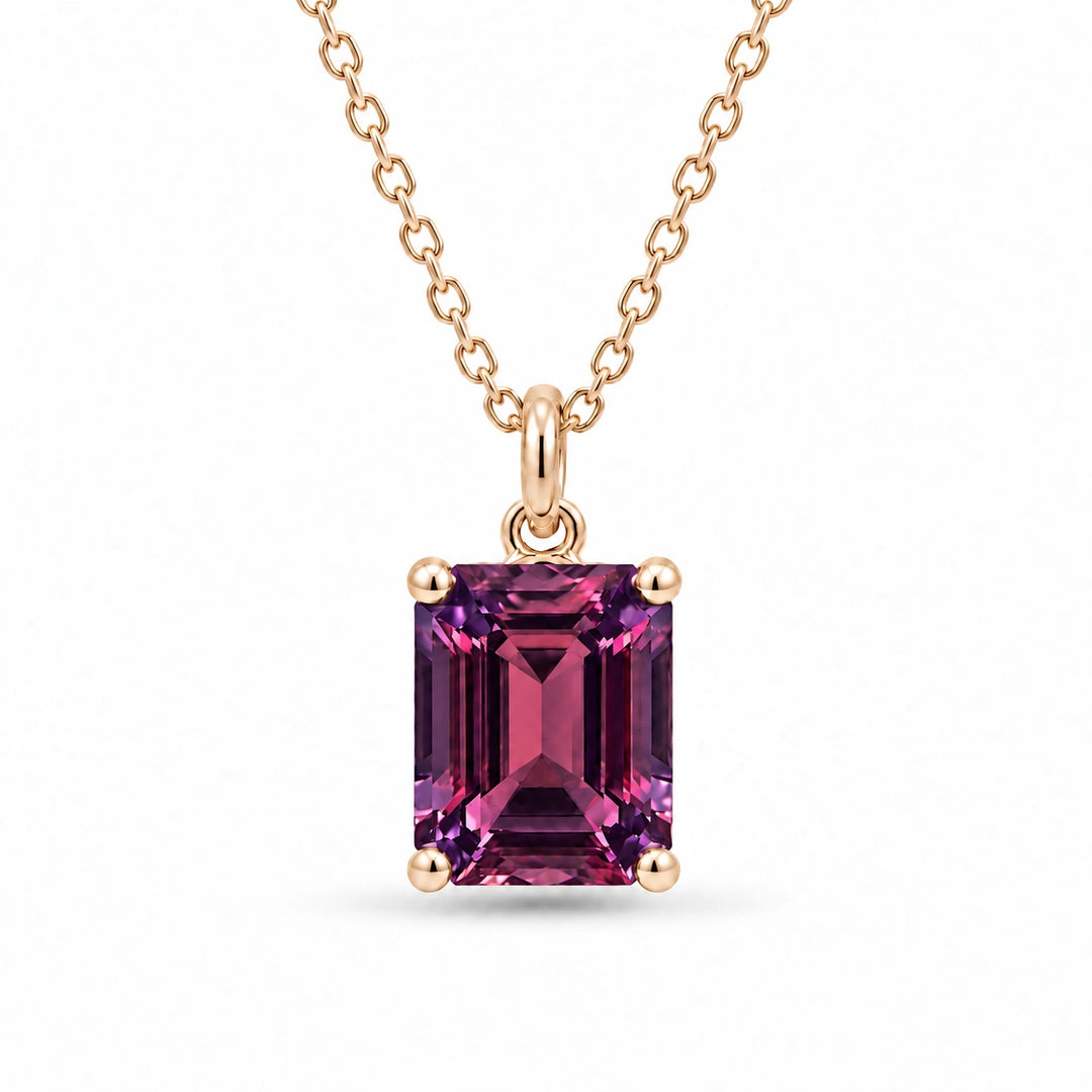 Emerald-Cut Lab Alexandrite Pendant in 14K Yellow Gold under warm indoor light, alexandrite color change