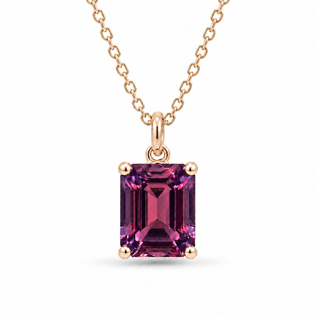 Emerald-Cut Lab Alexandrite Pendant in 14K Yellow Gold under warm indoor light, alexandrite color change