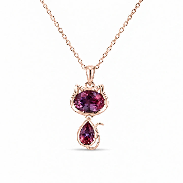 Cat Lab Alexandrite Pendant in 14K Rose Gold under warm indoor light, alexandrite color change