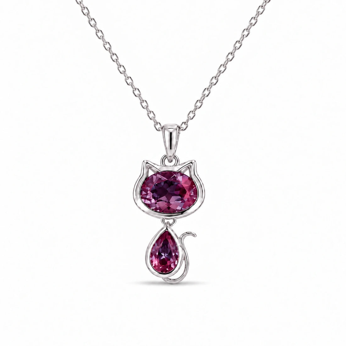 Cat Lab Alexandrite Pendant in 14K White Gold under warm indoor light, alexandrite color change