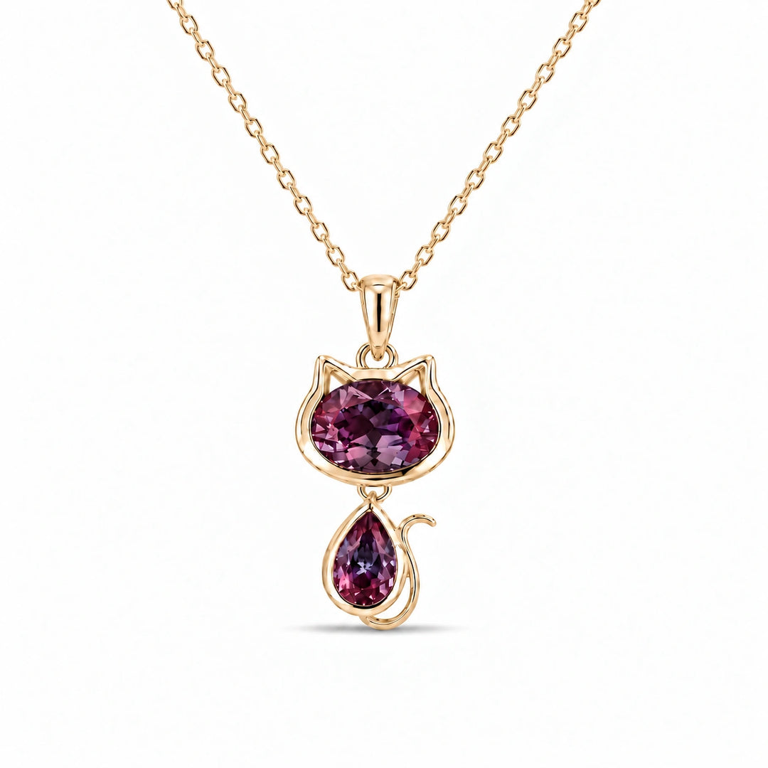 Cat Lab Alexandrite Pendant in 14K Yellow Gold under warm indoor light, alexandrite color change