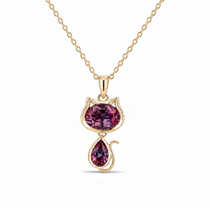 Cat Lab Alexandrite Pendant in 14K Yellow Gold under warm indoor light, alexandrite color change