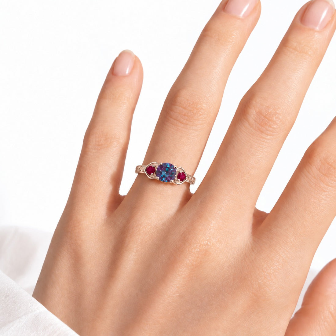 The Roserie — Alexandrite & Ruby Three-Stone Ring in 14K rose gold, worn on hand