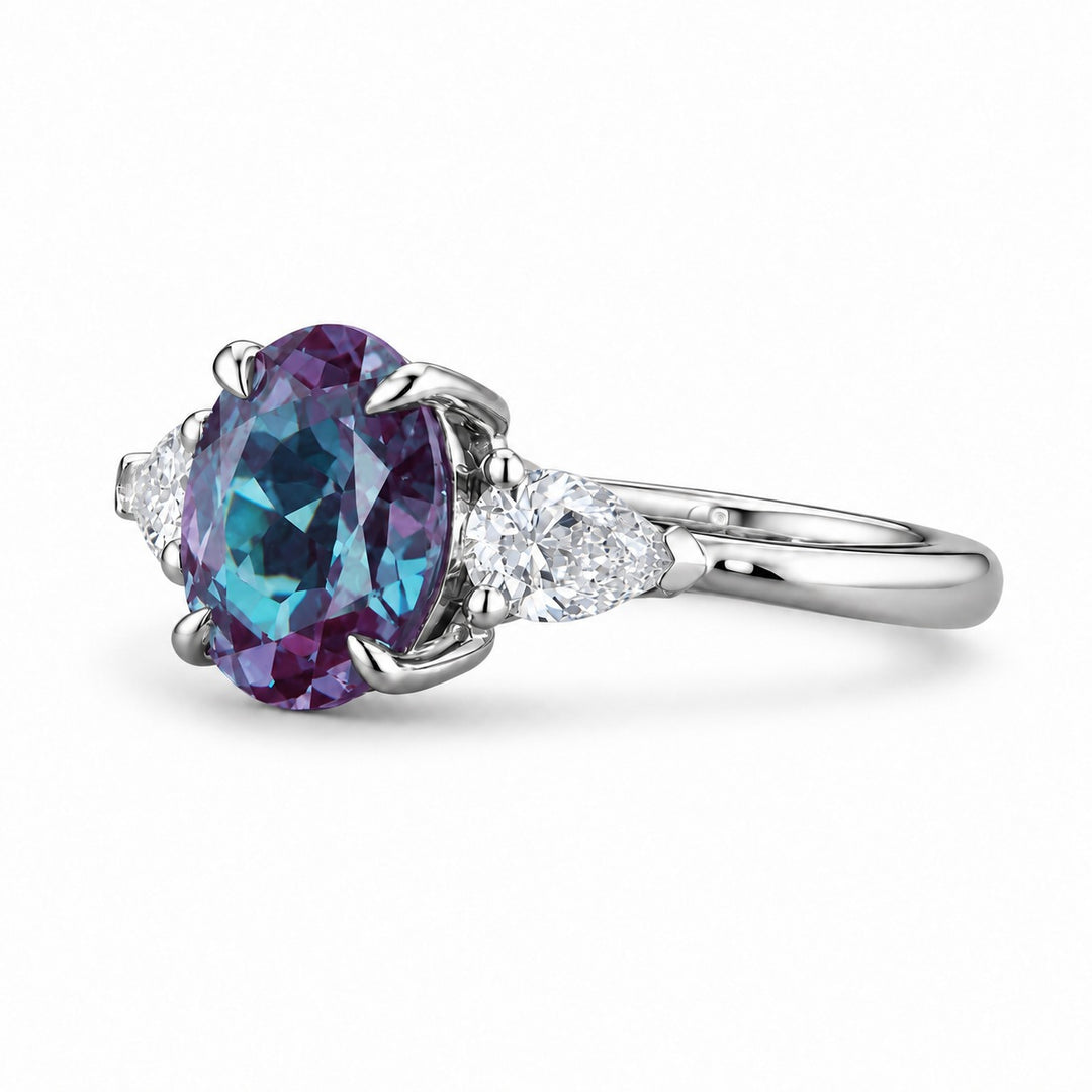 The Virelle — Oval Alexandrite Three-Stone Ring in platinum, angled view
