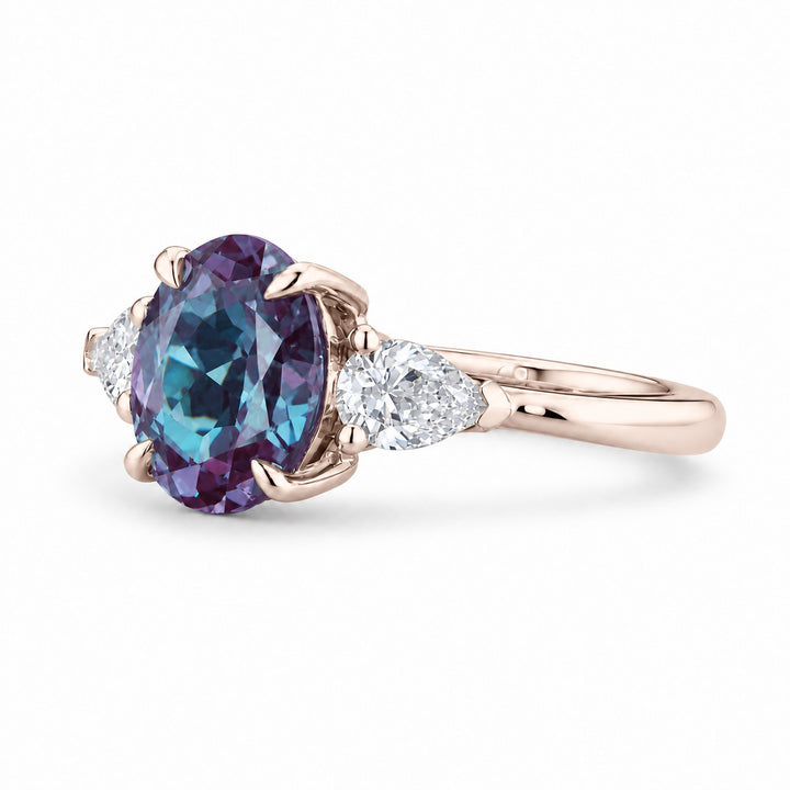 The Virelle — Oval Alexandrite Three-Stone Ring in 14K rose gold, angled view