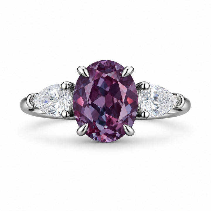 The Virelle — Oval Alexandrite Three-Stone Ring in platinum, in warm light