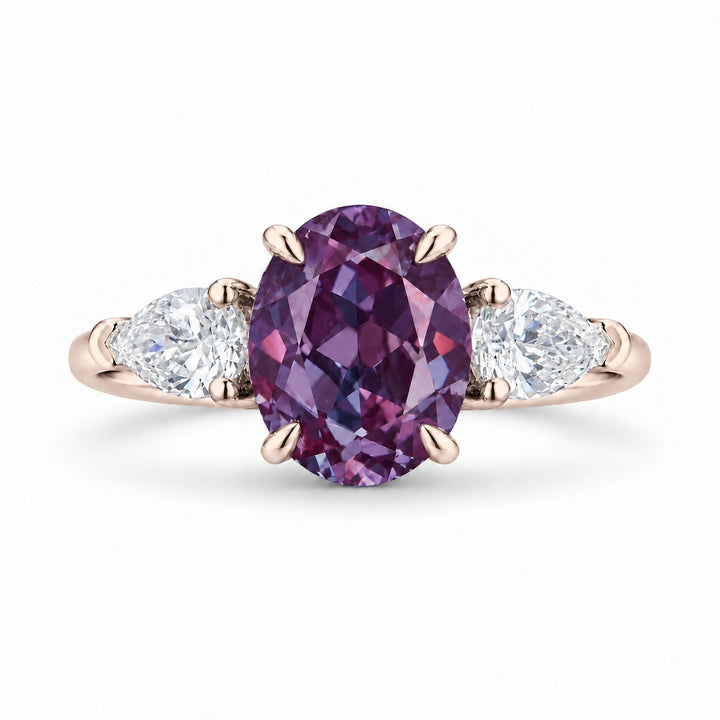 The Virelle — Oval Alexandrite Three-Stone Ring in 14K rose gold, in warm light