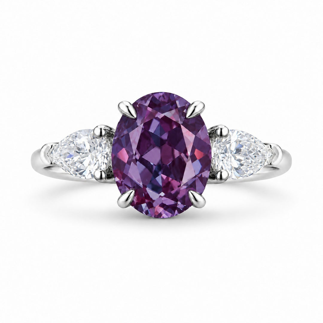 The Virelle — Oval Alexandrite Three-Stone Ring in 14K white gold, in warm light