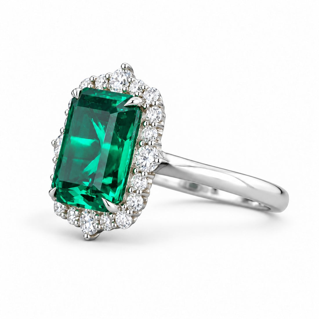 The Crown Halo — Diamond Halo Emerald Ring in 14K white gold, three-quarter view