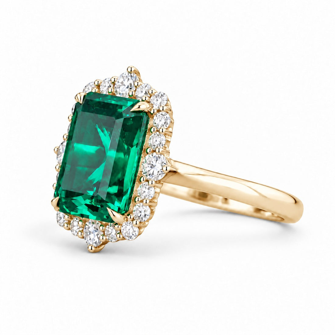 The Crown Halo — Diamond Halo Emerald Ring in 14K yellow gold, three-quarter view