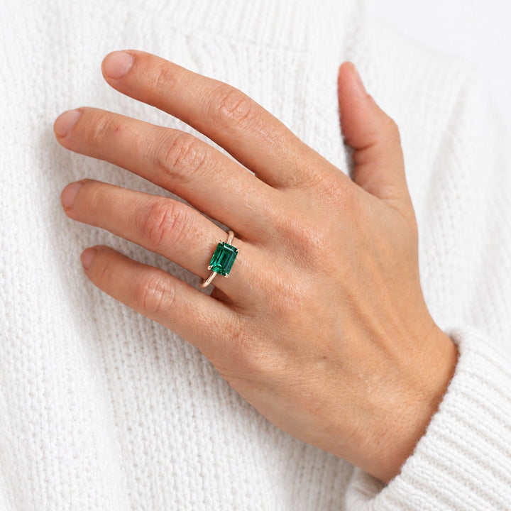The Linea — Emerald Ring in 14K rose gold, on the hand