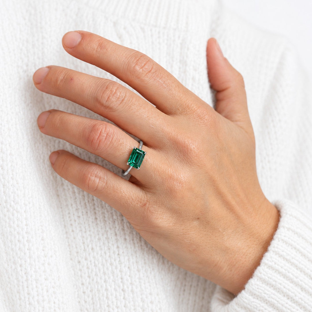 The Linea — Emerald Ring in 14K white gold, on the hand