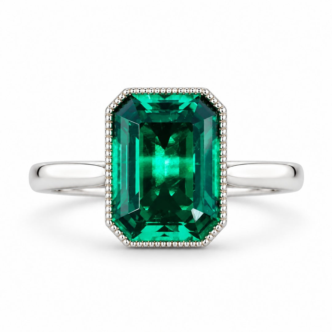 The Paragon — Milgrain Bezel Emerald Ring in 14K white gold, front view
