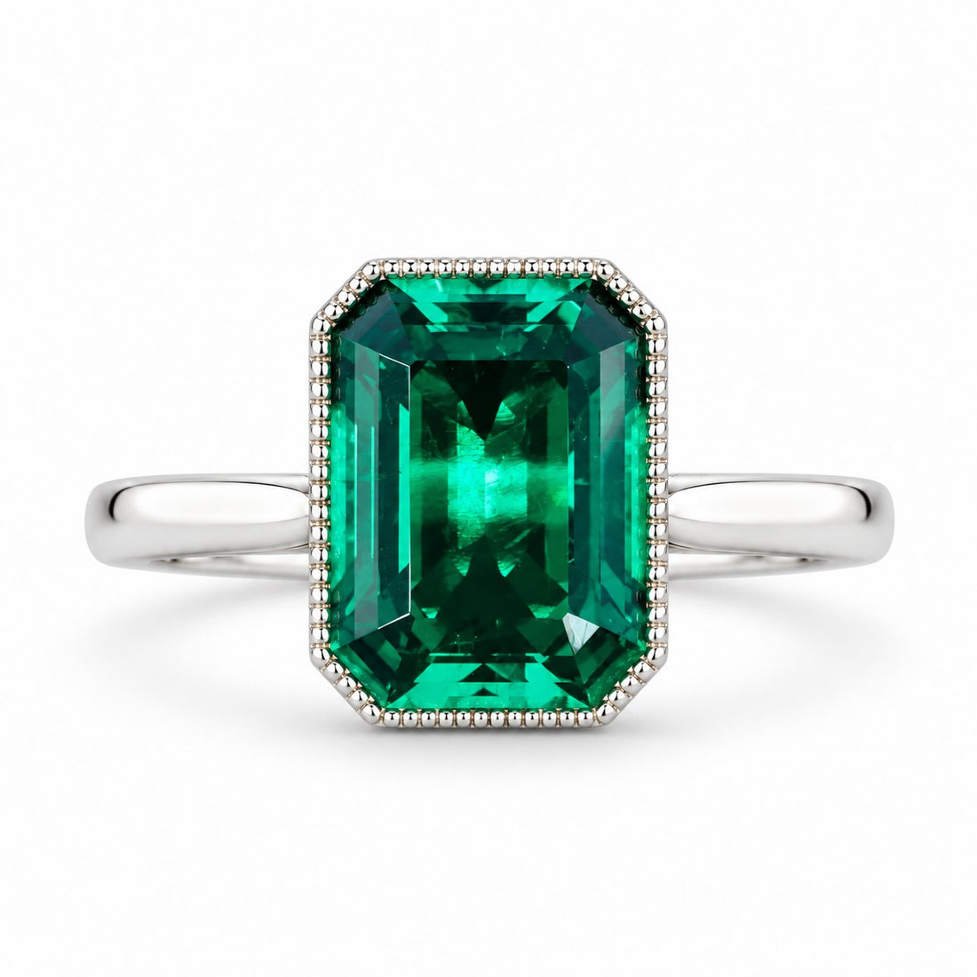 The Paragon — Milgrain Bezel Emerald Ring in 14K white gold, front view