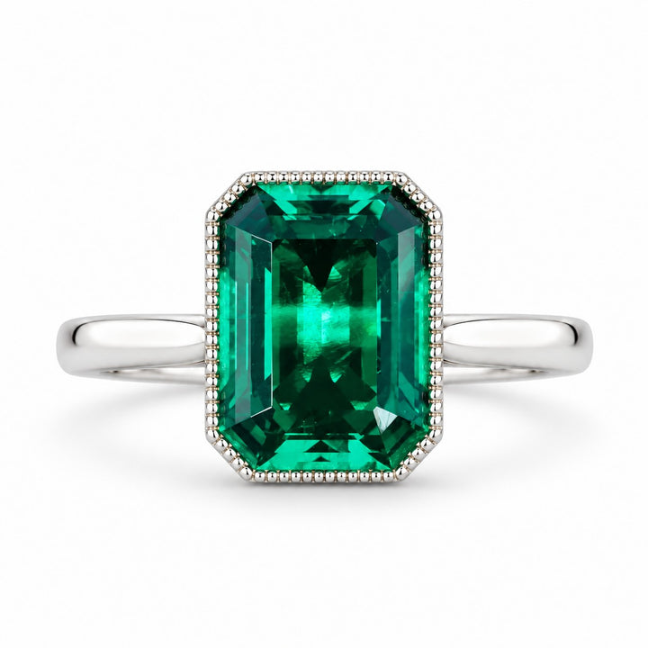The Paragon — Milgrain Bezel Emerald Ring in 14K white gold, front view