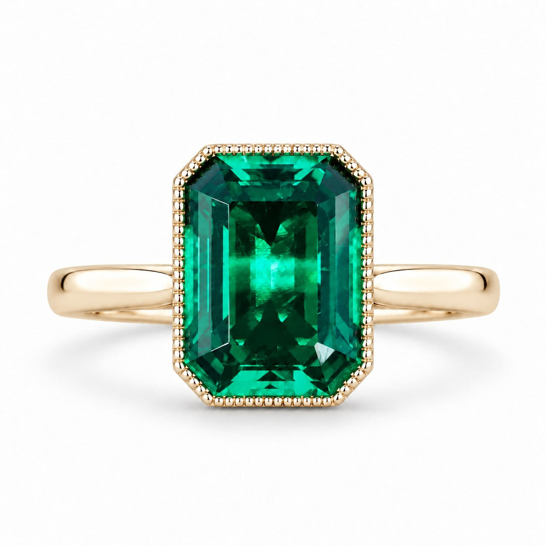 The Paragon — Milgrain Bezel Emerald Ring in 14K yellow gold, front view