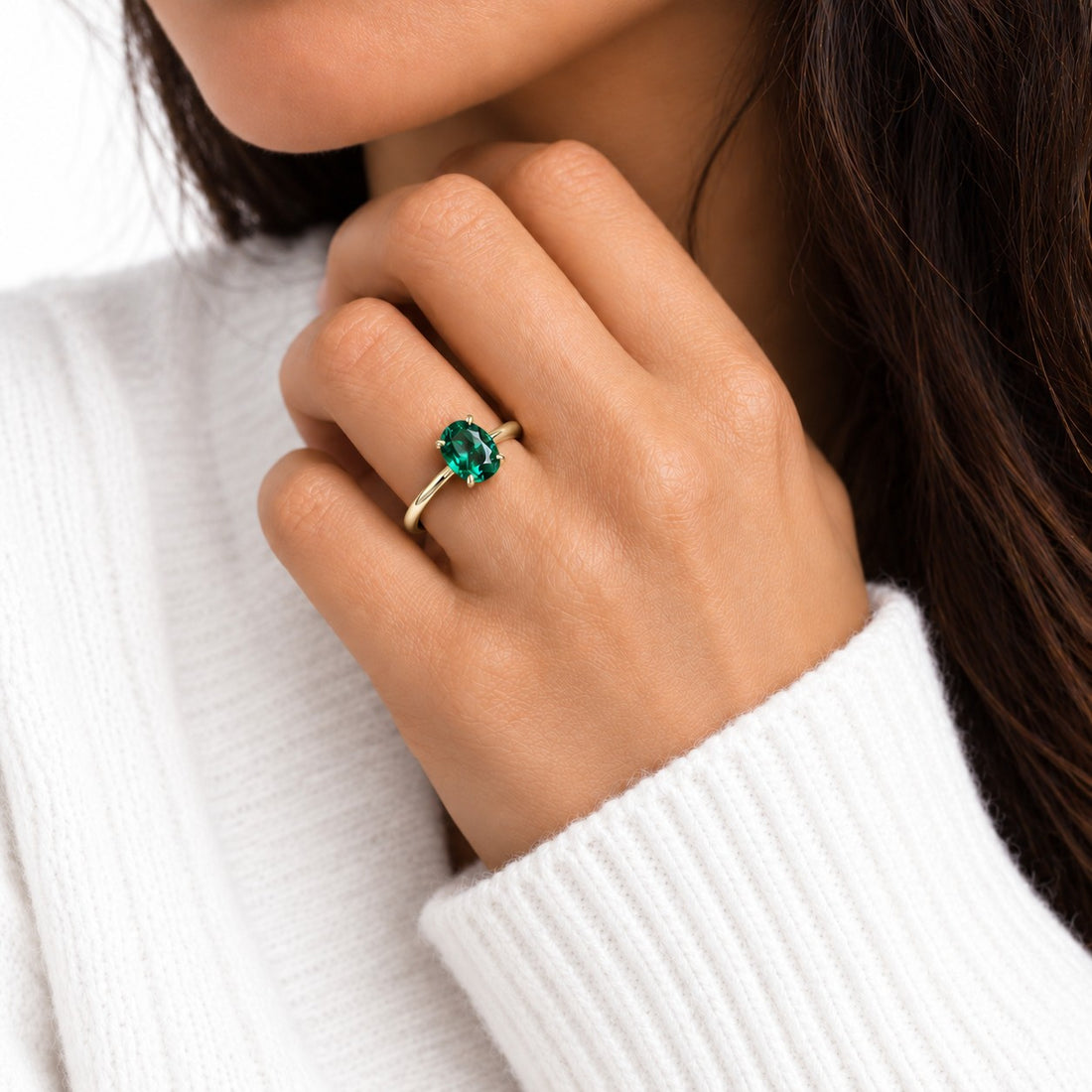 The Essence — Oval Emerald Ring in 14K yellow gold, on the hand