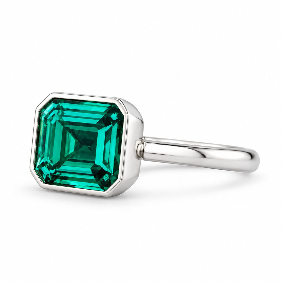 The Axis — East–West Emerald Ring in 14K white gold, three-quarter view