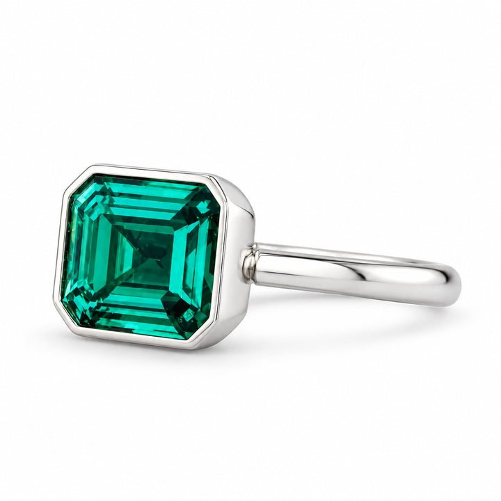 The Axis — East–West Emerald Ring in 14K white gold, three-quarter view
