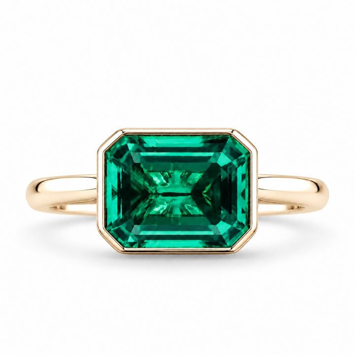The Axis — East–West Emerald Ring in 14K yellow gold, front view