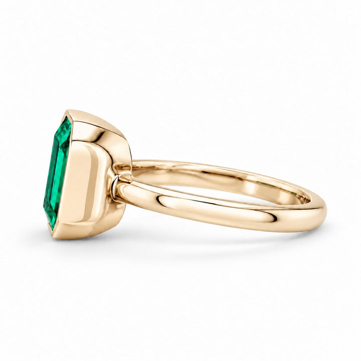 The Axis — East–West Emerald Ring in 14K yellow gold, side view