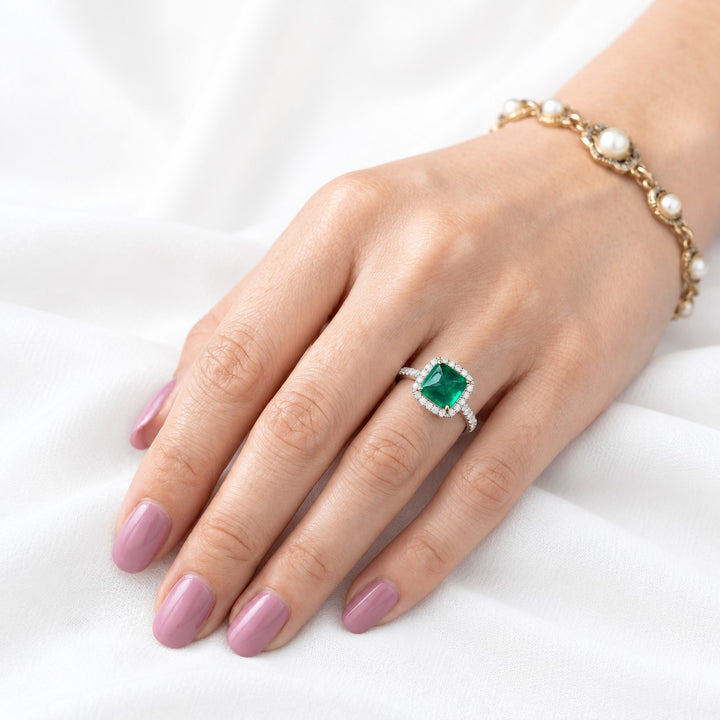The Prism — Diamond Halo Emerald Ring in 14K white gold, on the hand