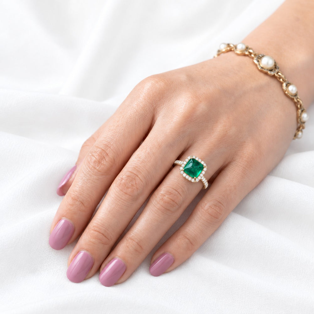 The Prism — Diamond Halo Emerald Ring in 14K yellow gold, on the hand