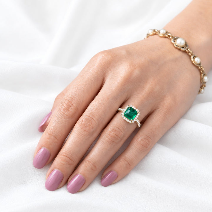 The Prism — Diamond Halo Emerald Ring in 14K yellow gold, on the hand