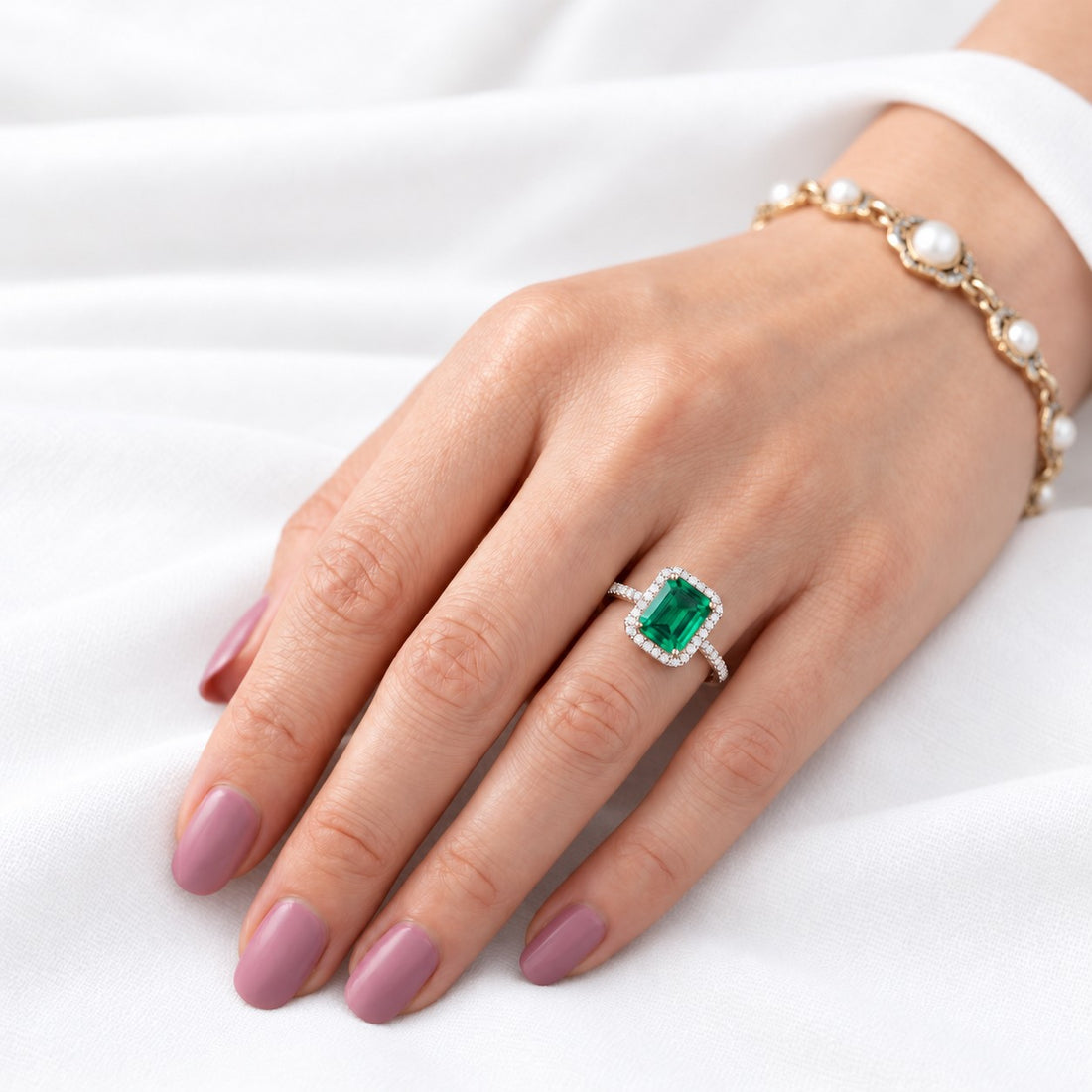 The Aurelia Halo — Diamond Halo/Band Emerald Ring in 14K rose gold, on the hand
